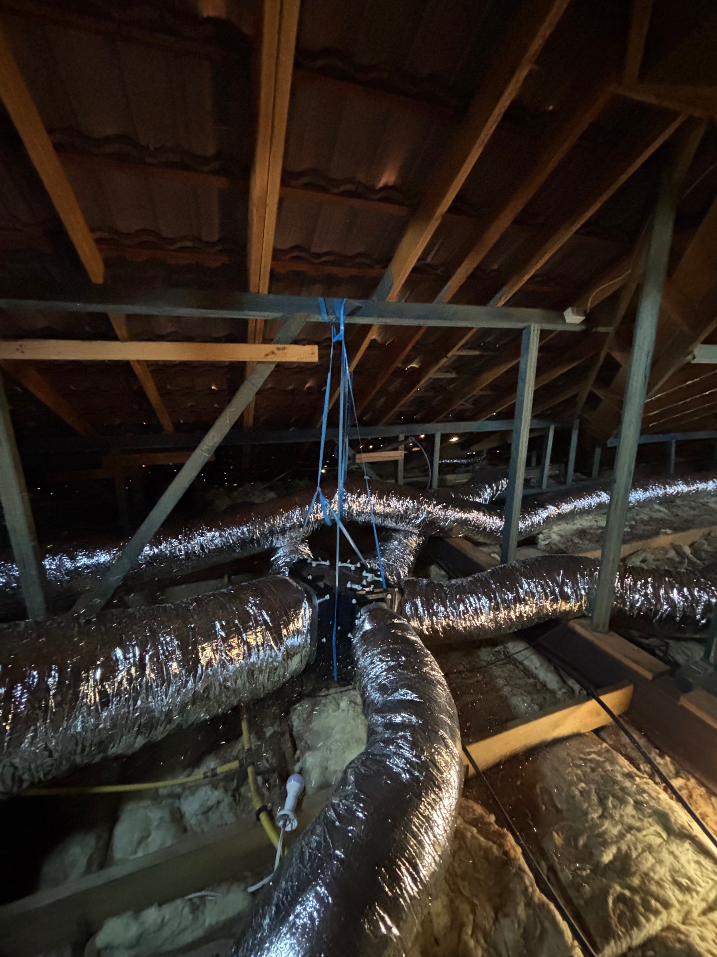Ducted air conditioning zone box with multiple flexible ducts branching out in a roof cavity